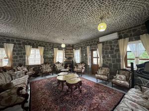 a living room with couches and a table at Bahçeli Taş Villa in Trabzon