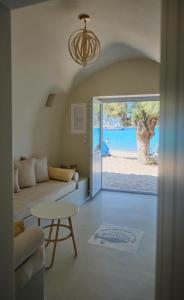 a living room with a couch and a table at Villa Aqua Blue 1 - Etheras properties in Diakofti