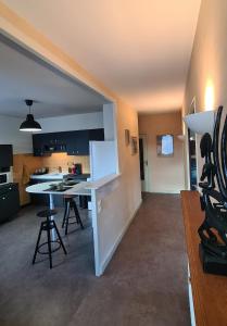 a kitchen with a white counter in a room at Appartement dans maison au calme in Oyonnax