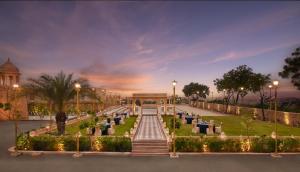 a park with a fountain and a building with lights at Storii By ITC Hotels, Jaisalmer in Jaisalmer