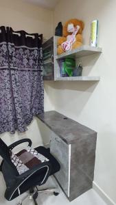 a desk and a chair in a room at skhanda family stay in Maula Ali +3 photos
