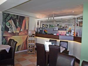 a restaurant with a bar with chairs and a counter at Pensiunea Paco in Cluj-Napoca