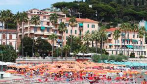 a group of umbrellas and chairs on a beach at vinga holiday's house in Imperia