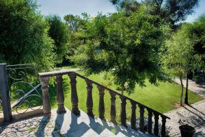 a staircase with a wrought iron railing and trees at Wineport Lodge Agva Riverside Hotel & Winery in Ağva
