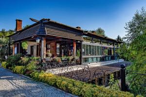 a building with tables and chairs in front of it at Wineport Lodge Agva Riverside Hotel & Winery in Ağva