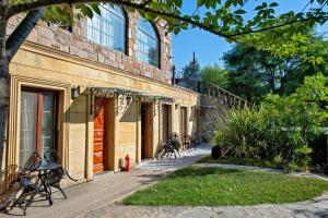 a building with benches sitting outside of it at Wineport Lodge Agva Riverside Hotel & Winery in Ağva