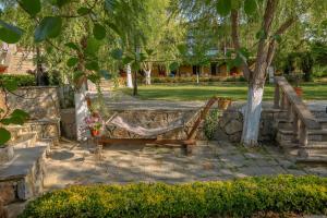 a hammock in a park with trees and stairs at Wineport Lodge Agva Riverside Hotel & Winery in Ağva