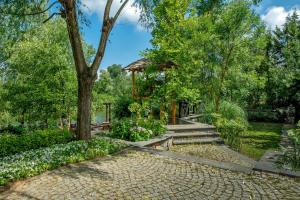 a garden with a gazebo and flowers at Wineport Lodge Agva Riverside Hotel & Winery in Ağva