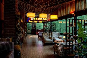 a lobby with couches and chairs in a building at Wineport Lodge Agva Riverside Hotel & Winery in Ağva