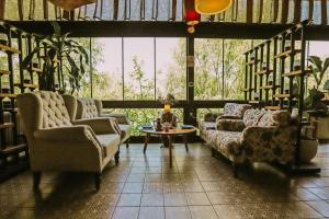 a living room with couches and a table and a large window at Wineport Lodge Agva Riverside Hotel & Winery in Ağva