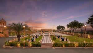 a park with a fountain and a building with lights at Storii By ITC Hotels, Jaisalmer in Jaisalmer