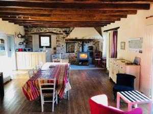 a living room with a table and a stone wall at La Mariotte in Montredon