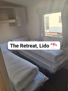 Dos camas en una habitación con el retiro ideo en The Retreat Lido Beach - Lido Beach Prestatyn, en Prestatyn