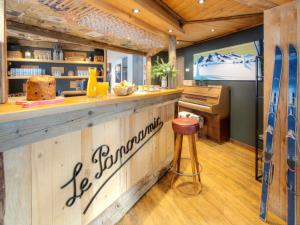 a restaurant with a counter with a bar with surfboards at Chalet 5★, 15 pers, pied des pistes, spa extérieur, 7 chambres - FR-1-304-308 in La Clusaz +19 photos