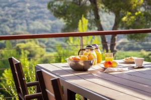 a table with a bowl of fruit and a bowl of juice at Hotiday Apartments Portoferraio in Portoferraio