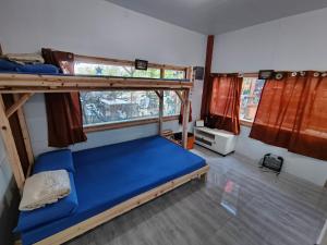 a bedroom with two bunk beds and a window at Red's Cafè & Resto- Glass Cabin in Manolo Fortich +35 photos