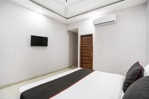 Postel nebo postele na pokoji v ubytování Hotel O Howdy