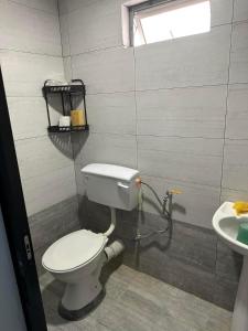 a bathroom with a toilet and a sink at Rejang Park Homestay 10Pax 3Rooms Free Wifi in Sibu