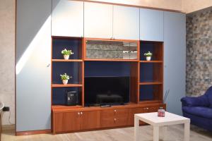 a living room with a large entertainment center with a tv at Meson Cavour in Avigliano