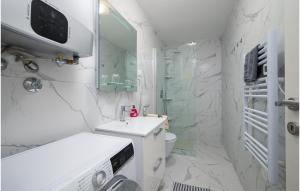 a white bathroom with a sink and a toilet at Apartman Porec Center Sea in Poreč