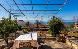 a table and chairs with a view of the ocean at 1 Bedroom Cozy Apartment In Kraljevica in Kraljevica