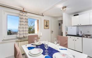a kitchen and dining room with a table with wine glasses at 1 Bedroom Cozy Apartment In Kraljevica in Kraljevica