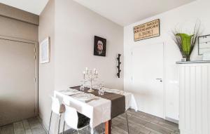 a white dining room with a table and chairs at Amazing Apartment In Oostende With Wifi in Ostend