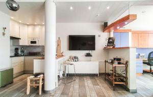 a kitchen with a column with a tv on the wall at Amazing Apartment In Oostende With Wifi in Ostend