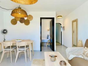 a living room with a table and a couch at Canaryislandshost I Dalia in Puerto del Carmen