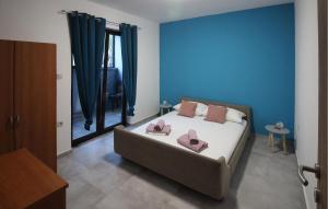 a bedroom with a bed with two pink pillows on it at Nice Apartment In Jakov Polje With Wifi in Krmpote-Vodice