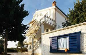ein weißes Gebäude mit einer Treppe und einem Fenster in der Unterkunft Amazing Apartment In Jezera With Wifi in Vrelo Koreničko