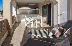 a patio with a table and chairs on a balcony at Primavera in Colònia De Sant Jordi