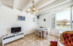 a living room with a television and a dining table at 2 Bedroom Cozy Home In Oradour-Fanais in Oradour-Fanais