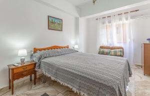 a bedroom with a bed and a table and a chair at Beautiful Apartment In Torrevieja in Torrevieja