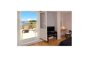 a bedroom with a view of the ocean from a balcony at Amazing Apartment In Makarska in Makarska