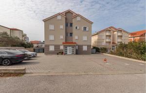 a man standing in a parking lot in front of a building at Awesome Apartment In Novalja With Wifi in Novalja
