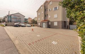 a person standing in the middle of a parking lot at Awesome Apartment In Novalja With Wifi in Novalja