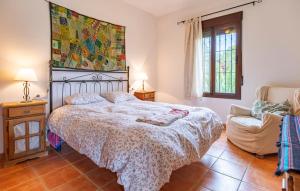 a bedroom with a large bed and a chair at Stunning Home In Álora With Wifi in Alora