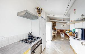 a kitchen with a stove top oven in a room at 2 Bedroom Cozy Home In Oradour-Fanais in Oradour-Fanais