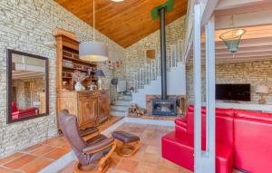 a living room with red furniture and a brick wall at Charmante Maison Proche Plage in Saint-Pierre-dʼOléron