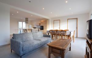 a living room with a couch and a table at Awesome Home In Bacilly With Wifi in Bacilly
