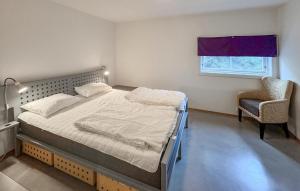 Un dormitorio con una cama y una silla y una ventana. en Lovely Apartment In Søgne With Wifi, en Søgne 11 fotos más