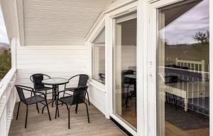 a patio with chairs and a table on a porch at 4 Bedroom Cozy Home In Lindesnes in Svenevik +19 photos