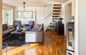 a living room with a couch and a staircase at 4 Bedroom Cozy Home In Lindesnes in Svenevik