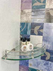 a glass shelf with two candles on a wall at VILLA M - JIA 3- 3BHK in Candolim, Pool Facing, Near Beach, Breakfast Included in Candolim