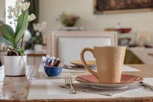 a table with a cup and a plate on it at Villa il Castagno Wine & Resort in Siena +48 photos