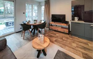 a living room with a table and a television at 2 Bedroom Gorgeous Home In Hellendoorn in Hellendoorn