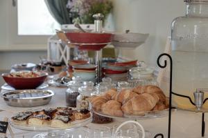 a table with pastries and other food items on it at Villa il Castagno Wine & Resort in Siena