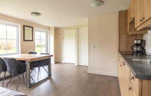 a kitchen with a table and chairs in a room at 2 Bedroom Stunning Home In Wagenborgen in Wagenborgen
