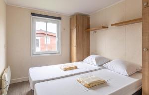 a white bed in a room with a window at 2 Bedroom Stunning Home In Wagenborgen in Wagenborgen